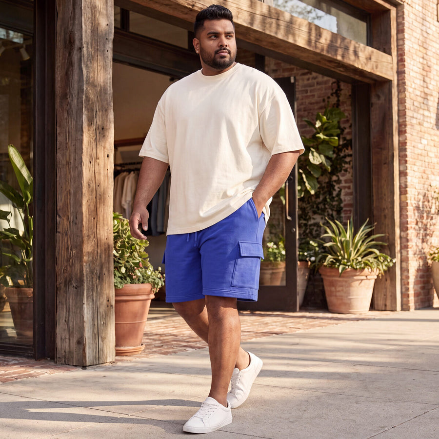 Plus-size man walking outdoors in blue FFlirtyGo cargo shorts