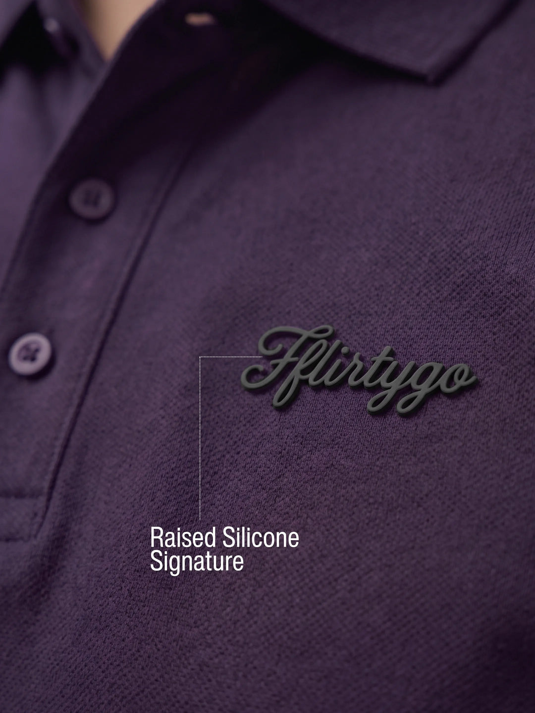 Raised silicone FFlirtyGo signature on the Deep Plum PurEase Core polo, close-up