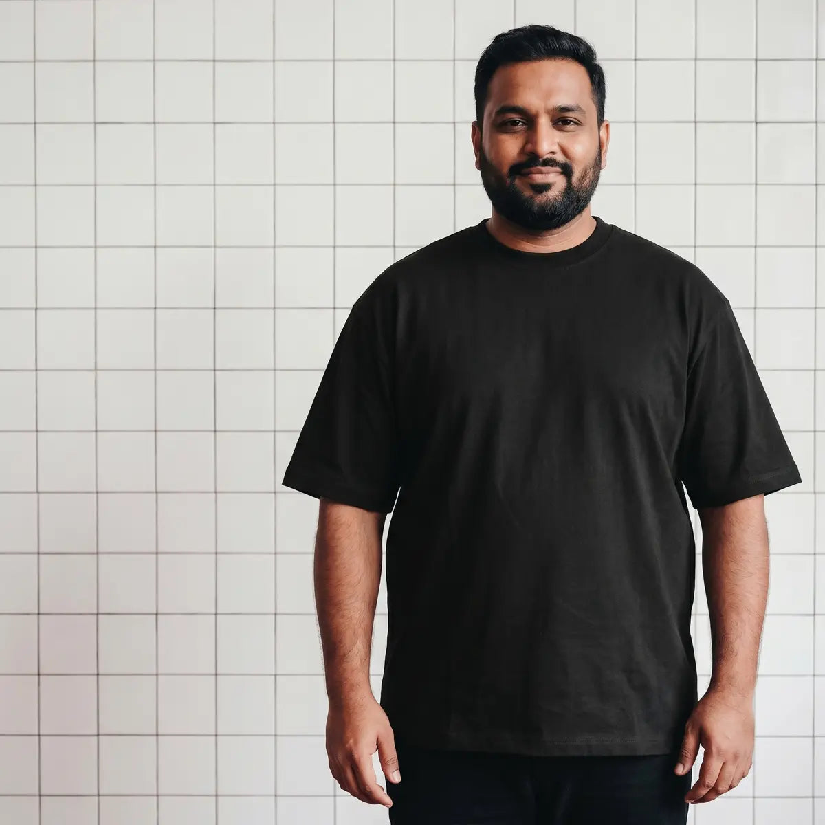 A real plus-size man wearing the basics tee in his true size