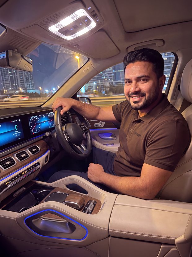 Man in an Espresso Brown PurEase polo at the wheel of a car